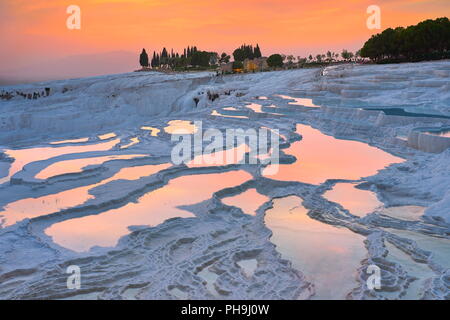 Pamukkale limestone terraces at sunset time, Pamukkale, Turkey Stock Photo