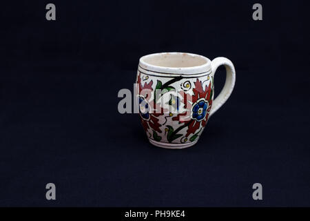 17th century Ottoman Turkish antique handmade cup , Kutahya, Turkey. isolated on black background Stock Photo