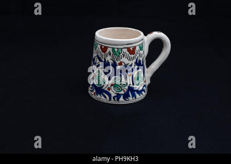 17th century Ottoman Turkish antique handmade cup , Kutahya, Turkey, isolated on black background Stock Photo