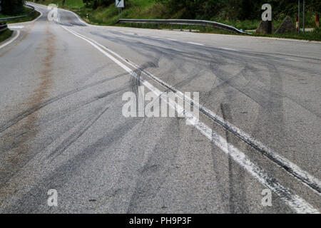 The rubber tracks from the racing cars left on the tarmac at the start of the hill climb stage. Stock Photo