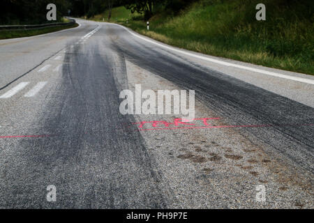 The rubber tracks from the racing cars left on the tarmac at the start of the hill climb stage. Stock Photo