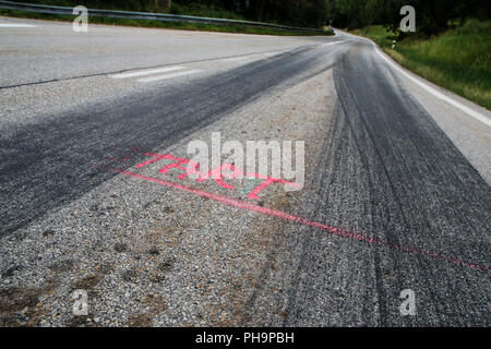 The rubber tracks from the racing cars left on the tarmac at the start of the hill climb stage. Stock Photo