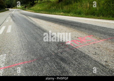 The rubber tracks from the racing cars left on the tarmac at the start of the hill climb stage. Stock Photo