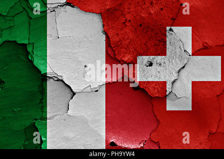 flags of Italy and Switzerland painted on cracked wall Stock Photo