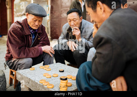 Men playing traditional game of Xiangqi (Chinese Chess), Dali, Yunnan Province, China, Asia Stock Photo