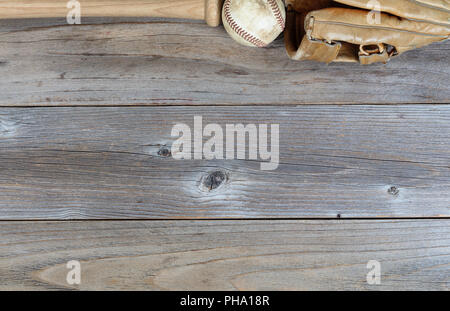 Top border of used baseball equipment on rustic wooden boards Stock Photo