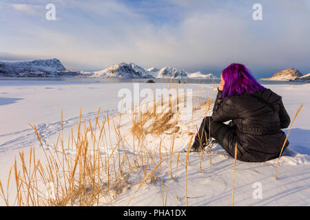 Woman on Haukland Beach covered with snow, Leknes, Vestvagoy, Lofoten Islands, Nordland, Norway, Europe Stock Photo