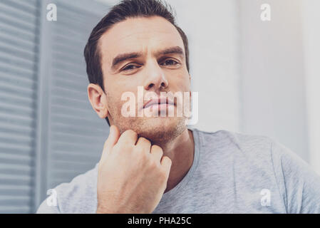 Dark-haired man feeling occupied working on business plan Stock Photo