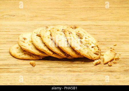 Milk chocolate almond cookies on a wooden board Stock Photo