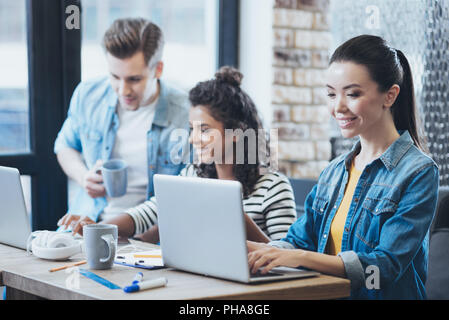 Joyful three students having project Stock Photo