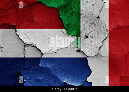 Flags of Netherlands and Italy  painted on cracked wall Stock Photo