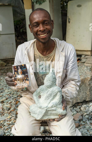 A stone carver seen in Harare, Zimbabwe Stock Photo
