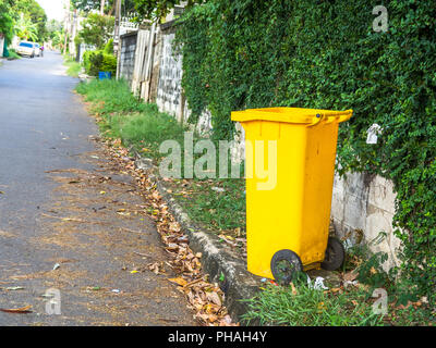 Yellow bins are placed on the side of the road in the village. Trash is for people in the village for left the garbage waiting to be Sorting for recyc Stock Photo