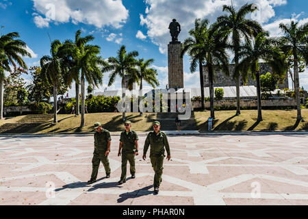 Santa Clara, Cuba / March 16, 2016: Three Cuban soldiers in green fatigues crossing plaza at the Che Guevara Mausoleum. Stock Photo