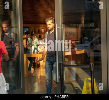 Customers in the Apple store in the Williamsburg neighborhood of Brooklyn in New York on Tuesday, August 28, 2018. (Â© Richard B. Levine) Stock Photo