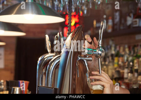 Barman pouring beer Stock Photo