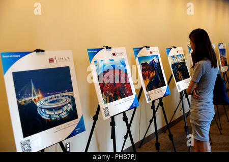 United Nations. 30th Aug, 2018. A woman looks at a photo during a tourism promotion of China's Chongqing, at the UN headquarters in New York Aug. 30, 2018. Chongqing Municipality in southwest China on Thursday held the event under the theme of 'A Tour in Chongqing, A Gain in Vision'. Credit: Li Muzi/Xinhua/Alamy Live News Stock Photo