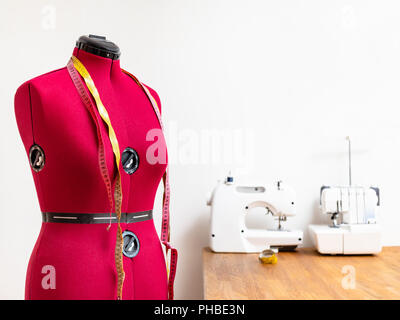 female form dummy with two measuring tapes in dressmaker workshop Stock Photo