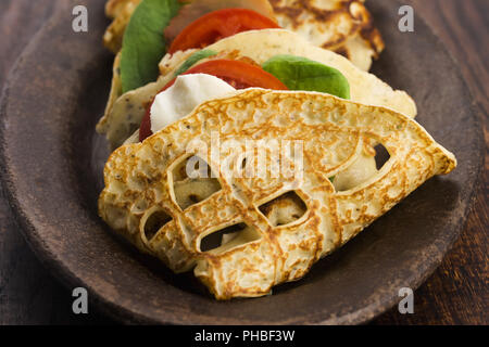 Pancakes sutffed with ham, cheese, tomatoes and spinach Stock Photo