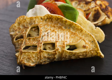 Pancakes sutffed with ham, cheese, tomatoes and spinach Stock Photo