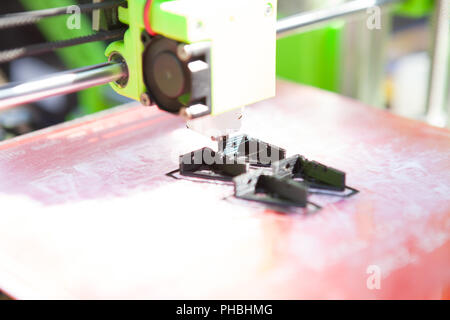 A desktop 3d printer in the laboratory for prints a structure from a polymer. Stock Photo