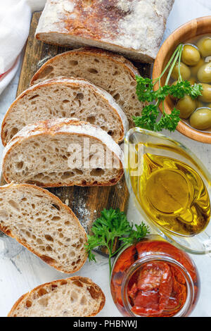 Homemade bread with olives,sun-dried tomatoes and olive oil. Stock Photo