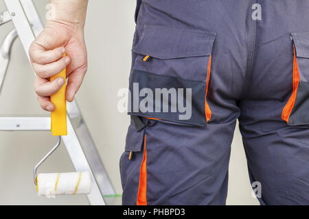 Man with paint roller Stock Photo