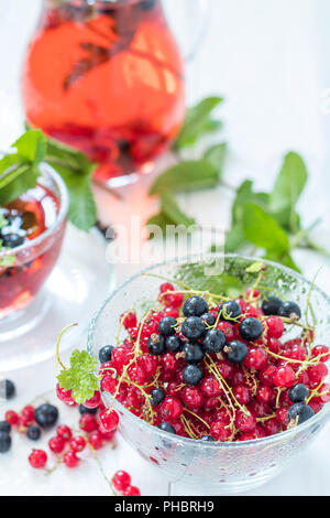 Fresh red and black currant in glass vase Stock Photo