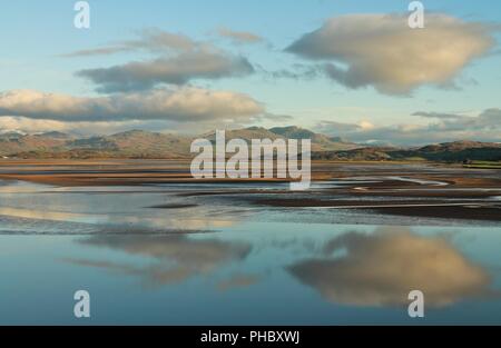 View from Dunnerholme. Reflections in the Duddon Estuary and the English Lake District Mountains in the distance. Viewed from the Cumbrian Coast. Stock Photo