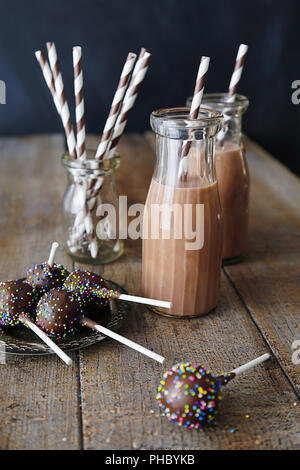 Bottles of tasty chocolate milk on table Stock Photo - Alamy