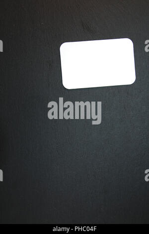 Blackboard with blank notepad Stock Photo