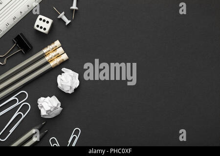 Office Accessories on Black Paper Background Stock Photo