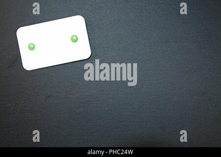 Blackboard with blank notepad Stock Photo