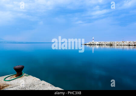 Small red lighthouse in Platamonas Greece. Stock Photo