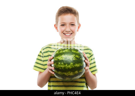 Handsome smiling child boy holding green watermelon fruit Stock Photo