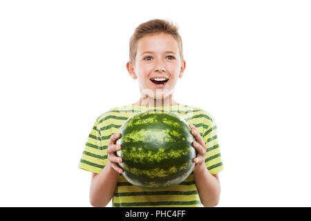 Handsome smiling child boy holding green watermelon fruit Stock Photo