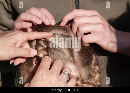 Head lice infection common in young people. Hair being checked using a special head lice comb. Stock Photo