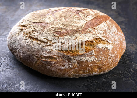Freshly backed Farmhouse Bread as close-up on an old griddle Stock Photo