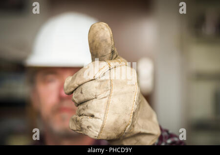 Construction worker showing hand with thumb up Stock Photo
