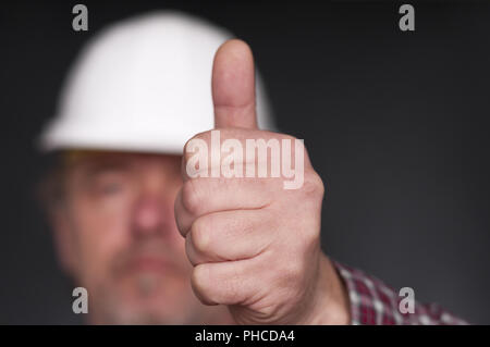 Construction worker showing hand with thumb up Stock Photo