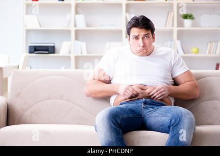 Man suffering from extra weight in diet concept Stock Photo