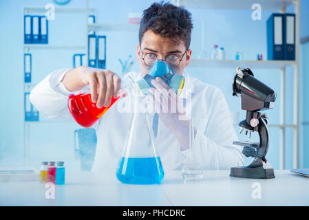 Funny mad chemist working in a laboratory Stock Photo