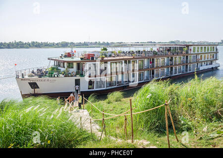 Chong Koh, Cambodia - April 9, 2018: Luxury cruise ship Mekong Prestige II owned by Cruise company Mekong Waterways anchored at the bank of Chong Koh Stock Photo