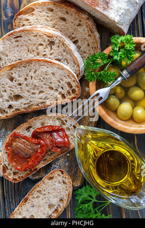 Fresh ciabatta, olives, oil and sun-dried tomatoes. Stock Photo