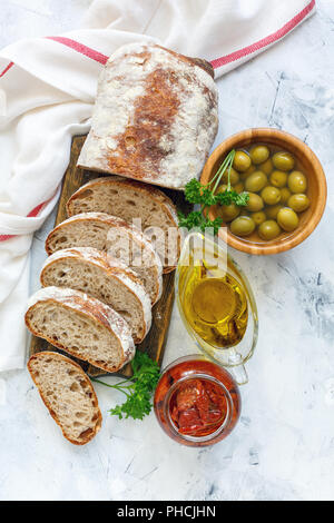 Homemade Italian bread, olives,sun-dried tomatoes and oil. Stock Photo