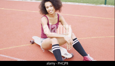 Confident sportive girl on skateboard Stock Photo