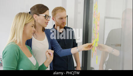 Young coworkers working on plan Stock Photo