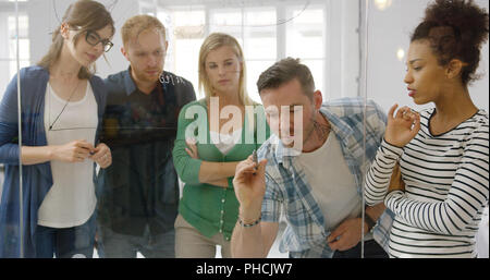 Interested colleagues taking part in work process Stock Photo
