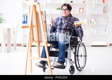 Disabled artist painting picture in studio Stock Photo