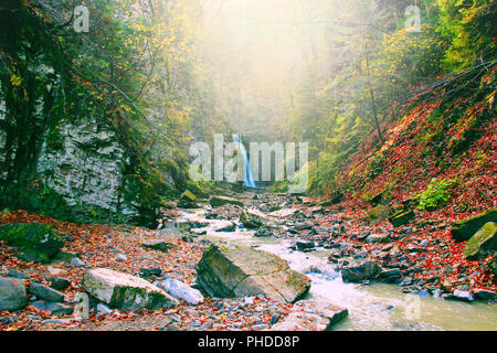 landscape with a waterfall and a mountain river in autumn Stock Photo